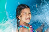 Little girl on water slide