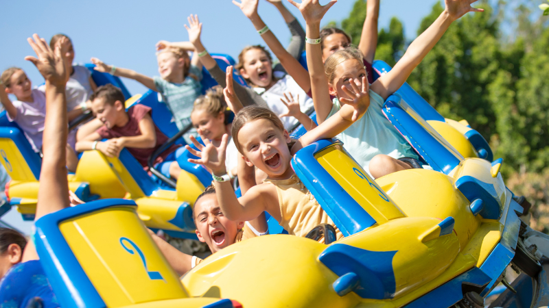 kids riding Rocking Tug ride at Castle Park