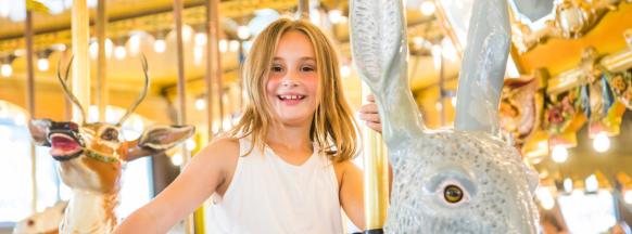 Girl smiling on Carousel
