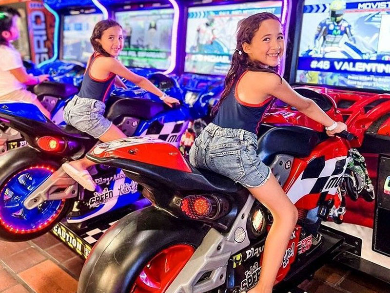 Girls having fun on motorcycle game