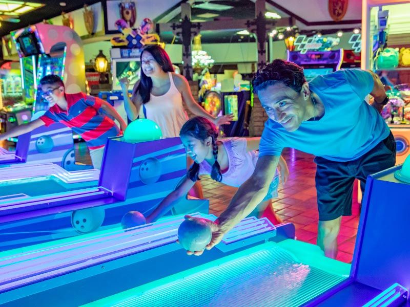 Teens playing at arcade