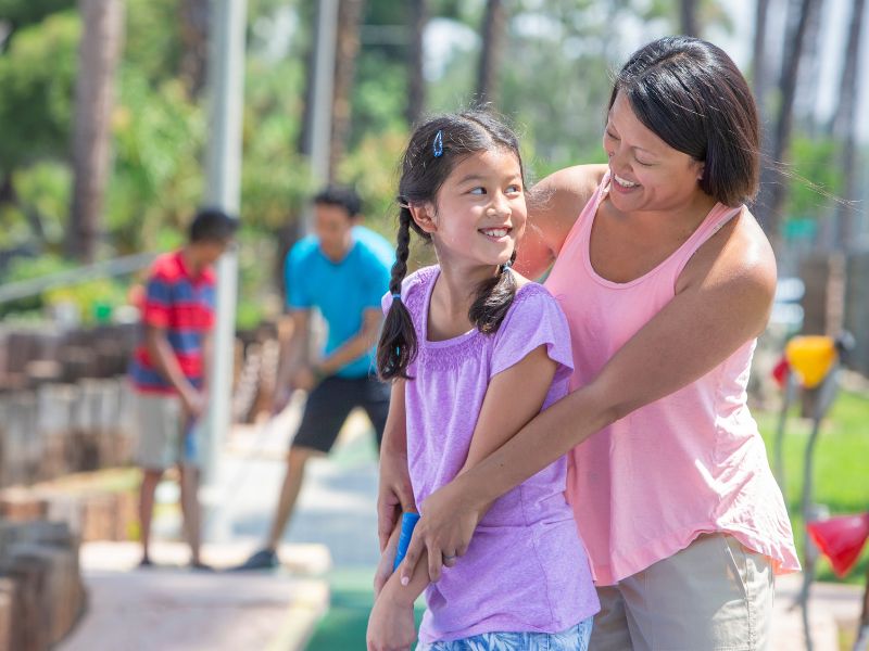 Teens playing mini golf