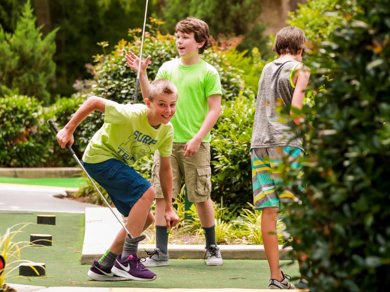 Teens playing mini golf